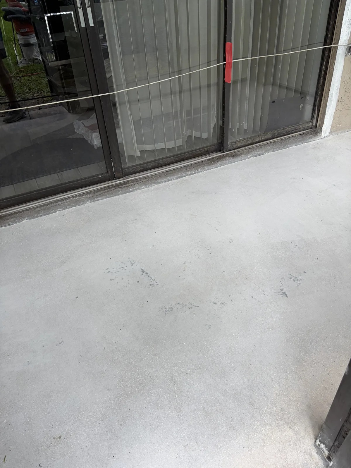 Worn concrete patio before grey flake system